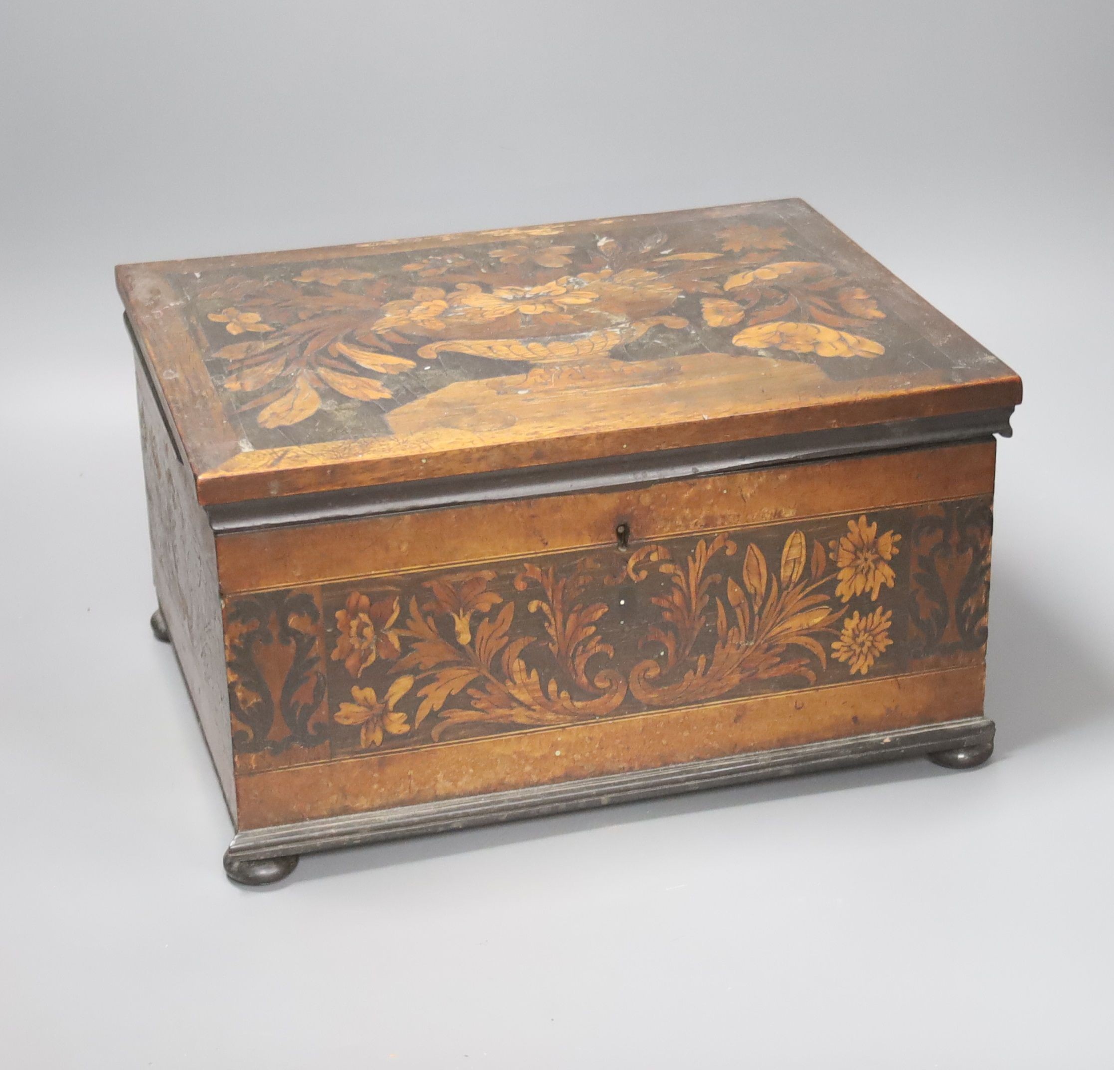 An unusual George IV ebony and marquetry inlaid tea caddy, 32cm